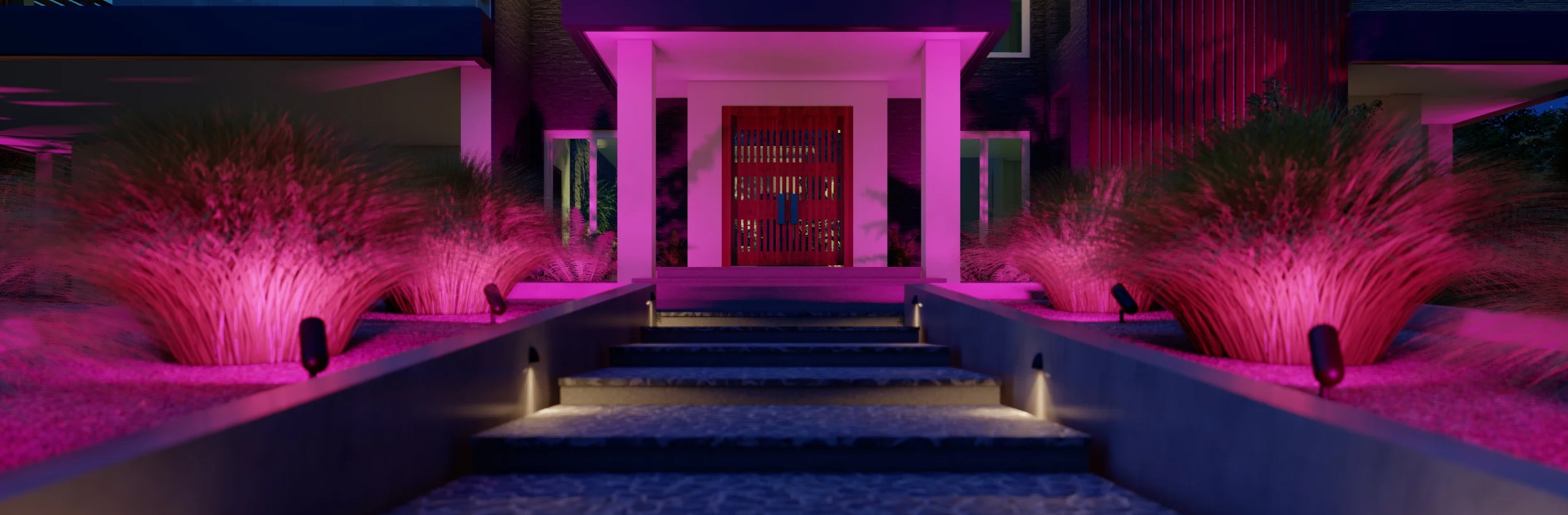 Cozy kitchen with wooden cabinets, recessed ceiling lights, and a staircase in the background.