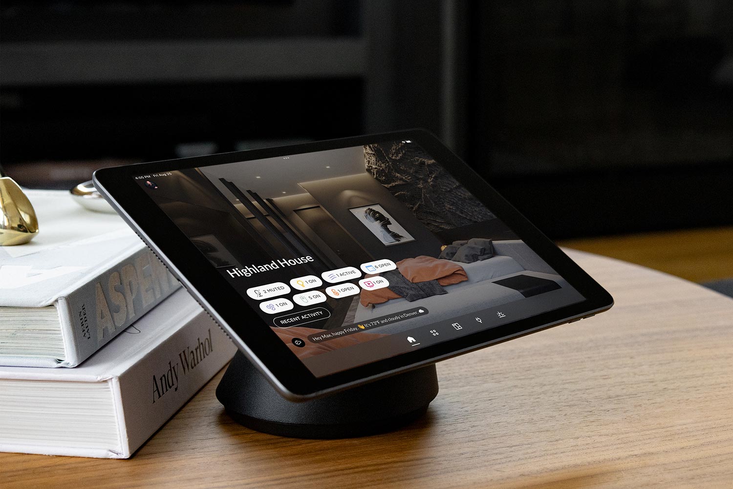 Josh AI Touch panel in a able with a traditional home in the background