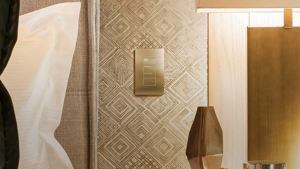 Minimalist black touch-sensitive Lutron light switch on a white wall in a bright, modern home.